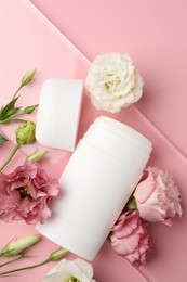 Photo of Solid deodorant and beautiful eustoma flowers on pink background, top view