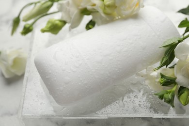 Photo of Solid deodorant and beautiful eustoma flowers on table, closeup