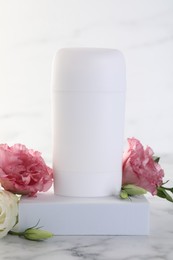 Photo of Solid deodorant and beautiful eustoma flowers on white marble table