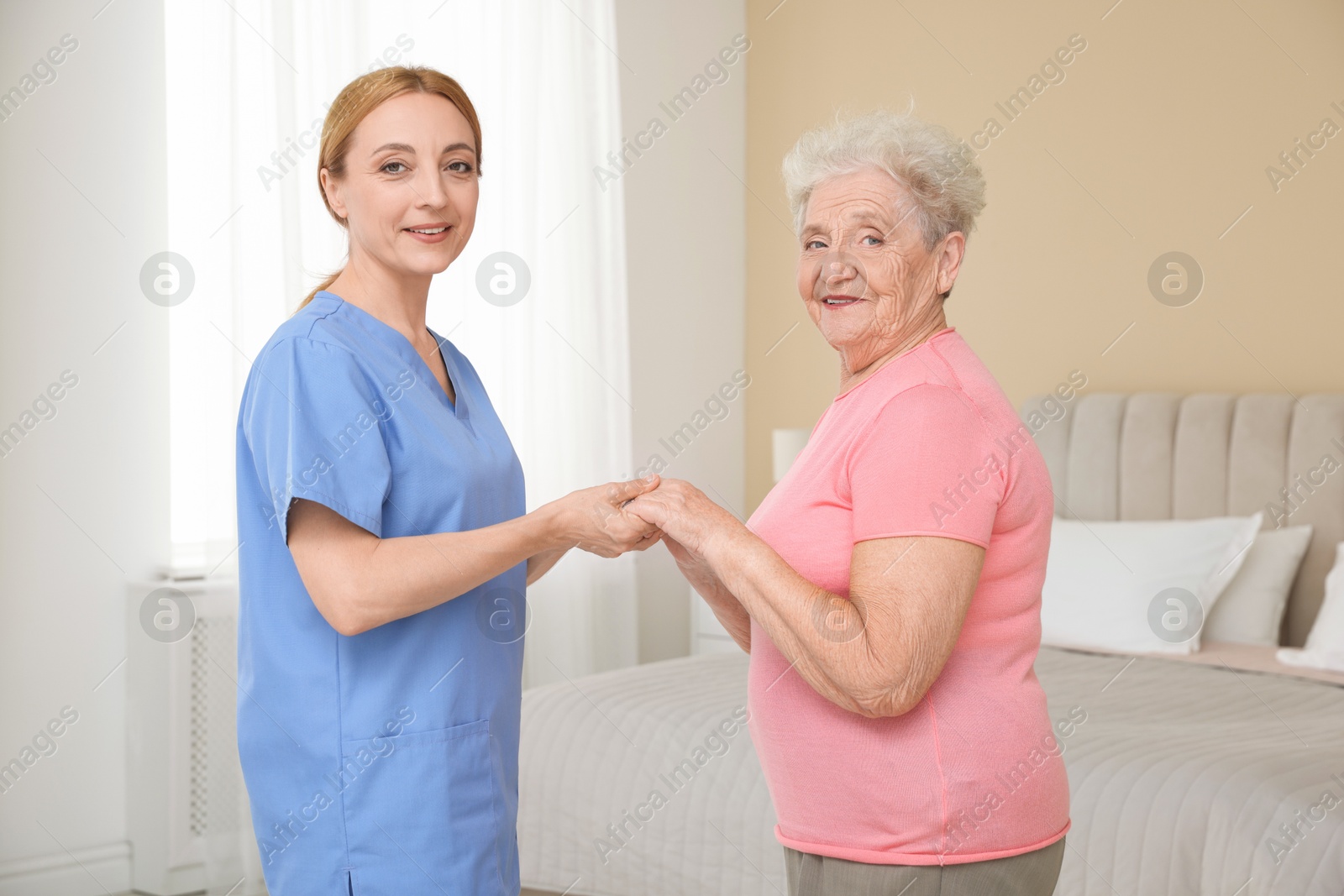 Photo of Healthcare worker supporting senior patient at home