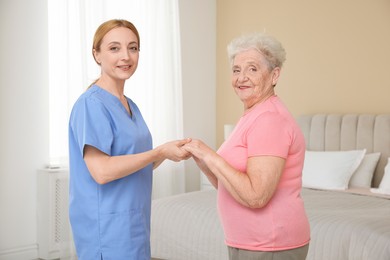 Photo of Healthcare worker supporting senior patient at home