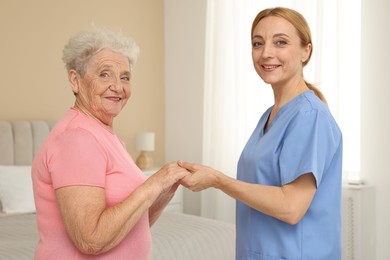 Healthcare worker supporting senior patient at home