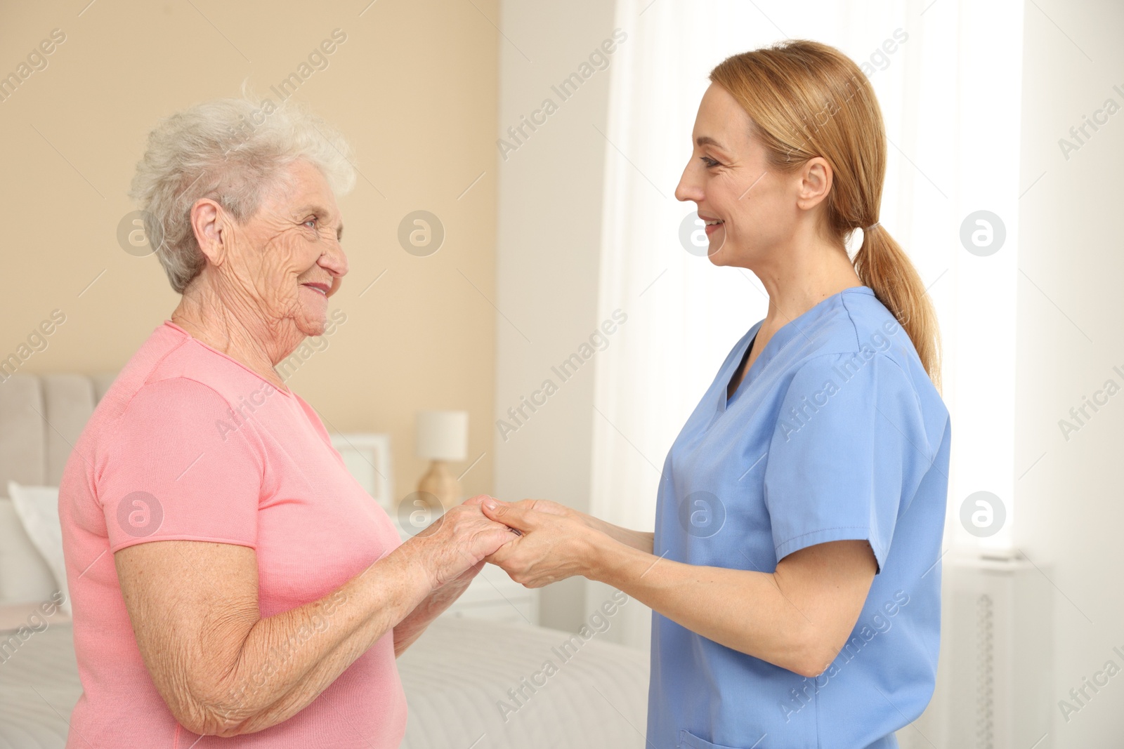 Photo of Healthcare worker supporting senior patient at home