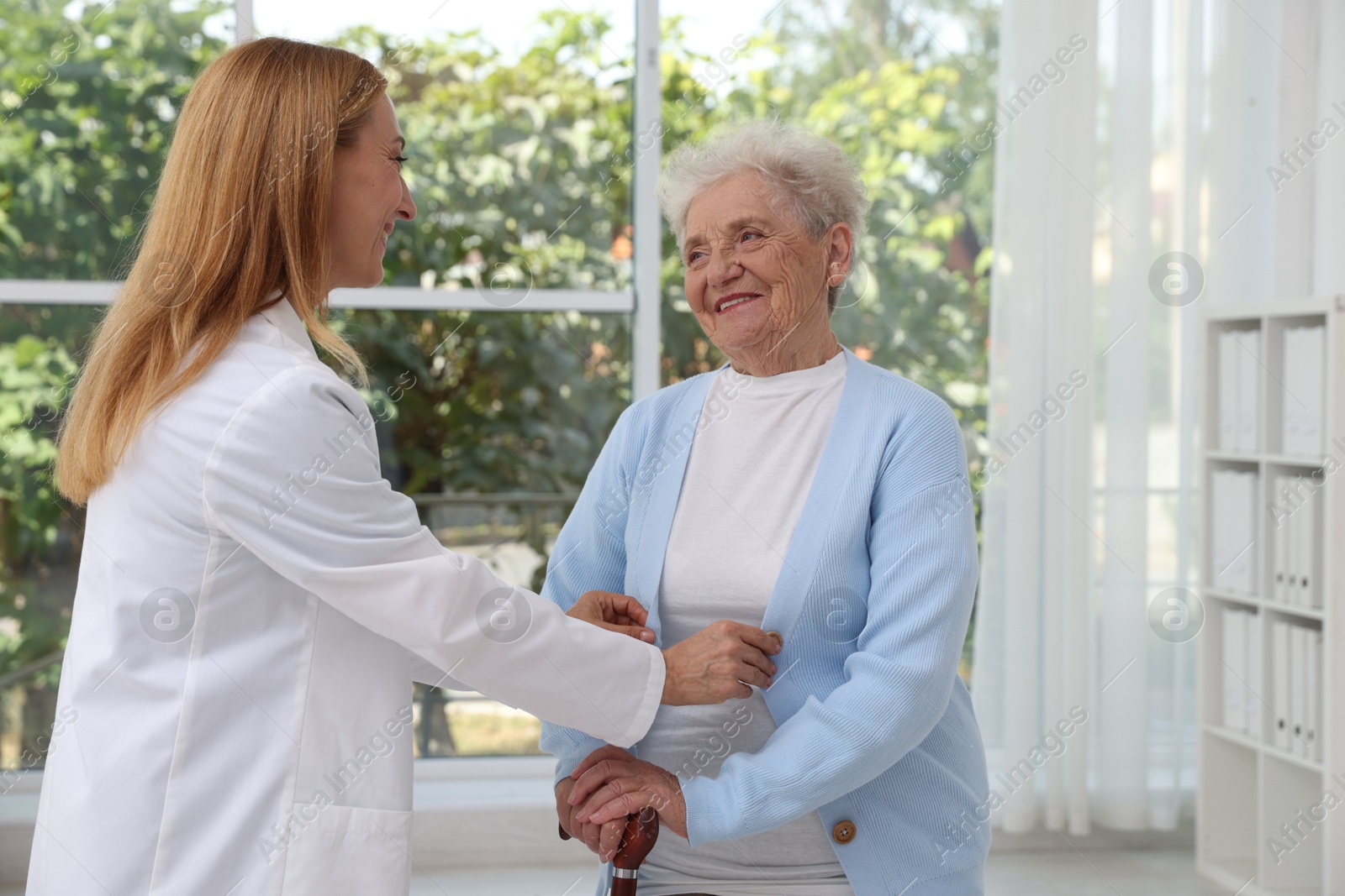 Photo of Healthcare worker supporting senior patient in hospital