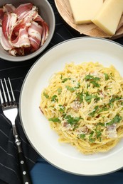 Photo of Delicious pasta Carbonara served on table, flat lay