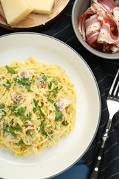 Photo of Delicious pasta Carbonara served on table, flat lay