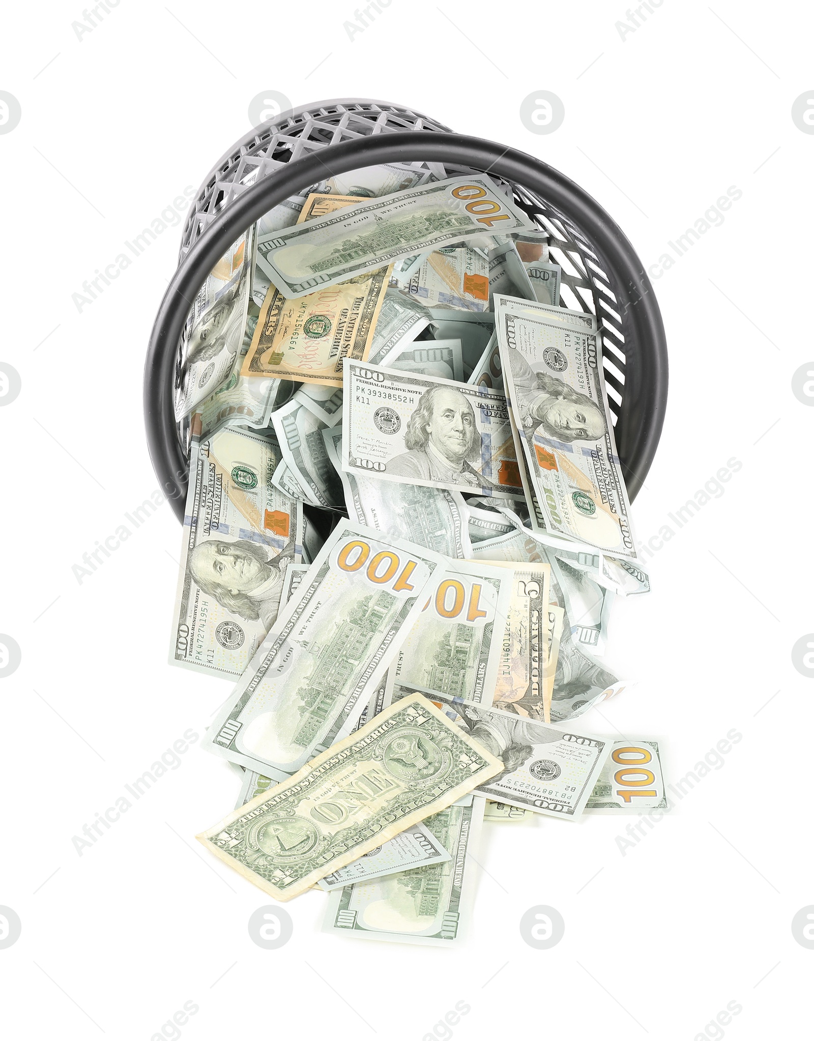 Photo of Many dollar banknotes and overturned trash bin isolated on white