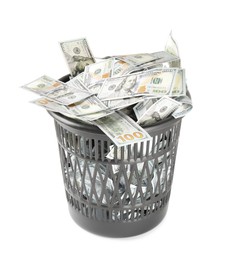 Photo of Many dollar banknotes in trash bin isolated on white