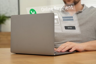 Image of Online payment system interface over computer. Man working on laptop at desk, closeup