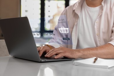 Image of Online payment system interface over computer. Man working on laptop at desk, closeup