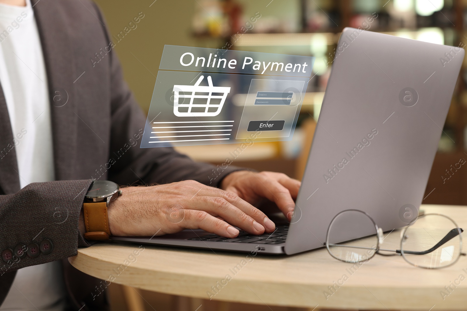 Image of Online payment system interface over computer. Man working on laptop at table, closeup