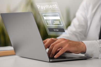 Image of Online payment system interface over computer. Man working on laptop at desk, closeup