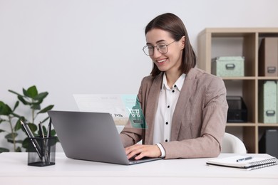 Online payment system interface over computer. Woman working on laptop at desk in office