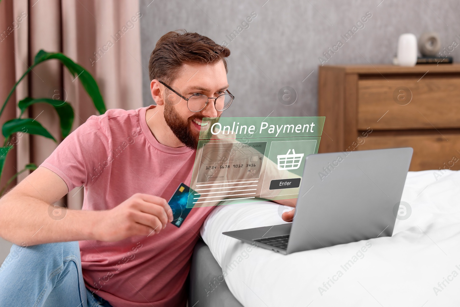 Image of Online payment system interface over computer. Man working on laptop at desk in office