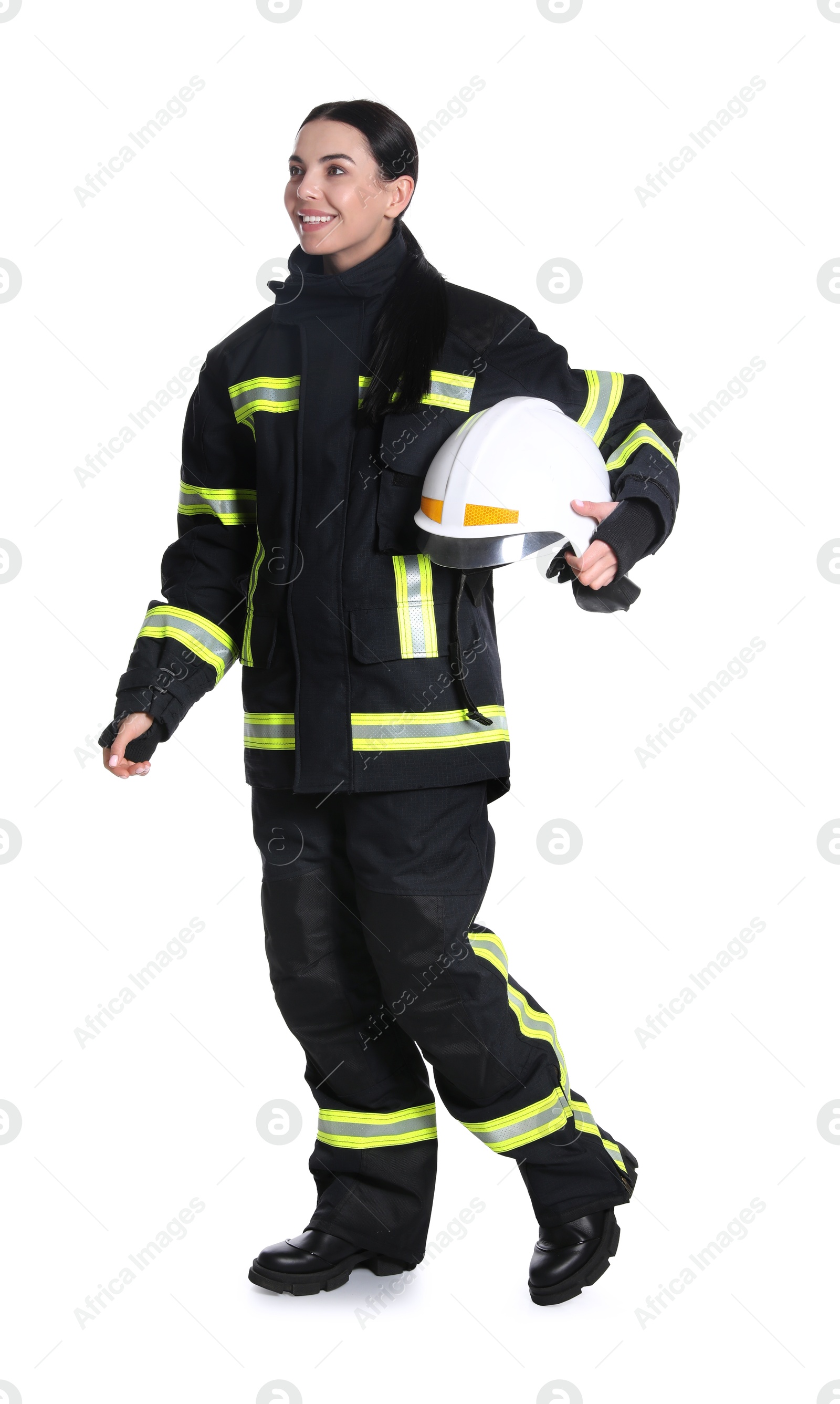 Photo of Full length portrait of firefighter in uniform with helmet on white background