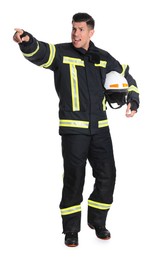 Full length portrait of firefighter in uniform with helmet on white background