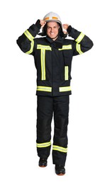 Full length portrait of firefighter in uniform wearing helmet on white background