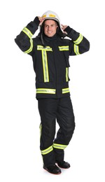 Photo of Full length portrait of firefighter in uniform wearing helmet on white background