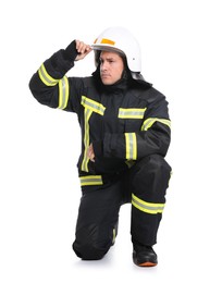 Photo of Full length portrait of firefighter in uniform and helmet on white background