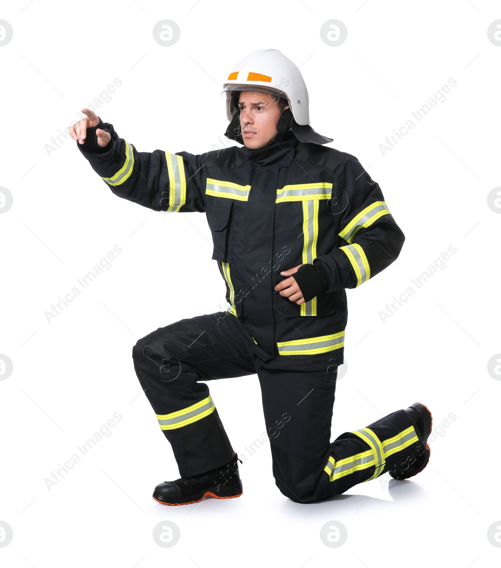 Photo of Full length portrait of firefighter in uniform and helmet on white background