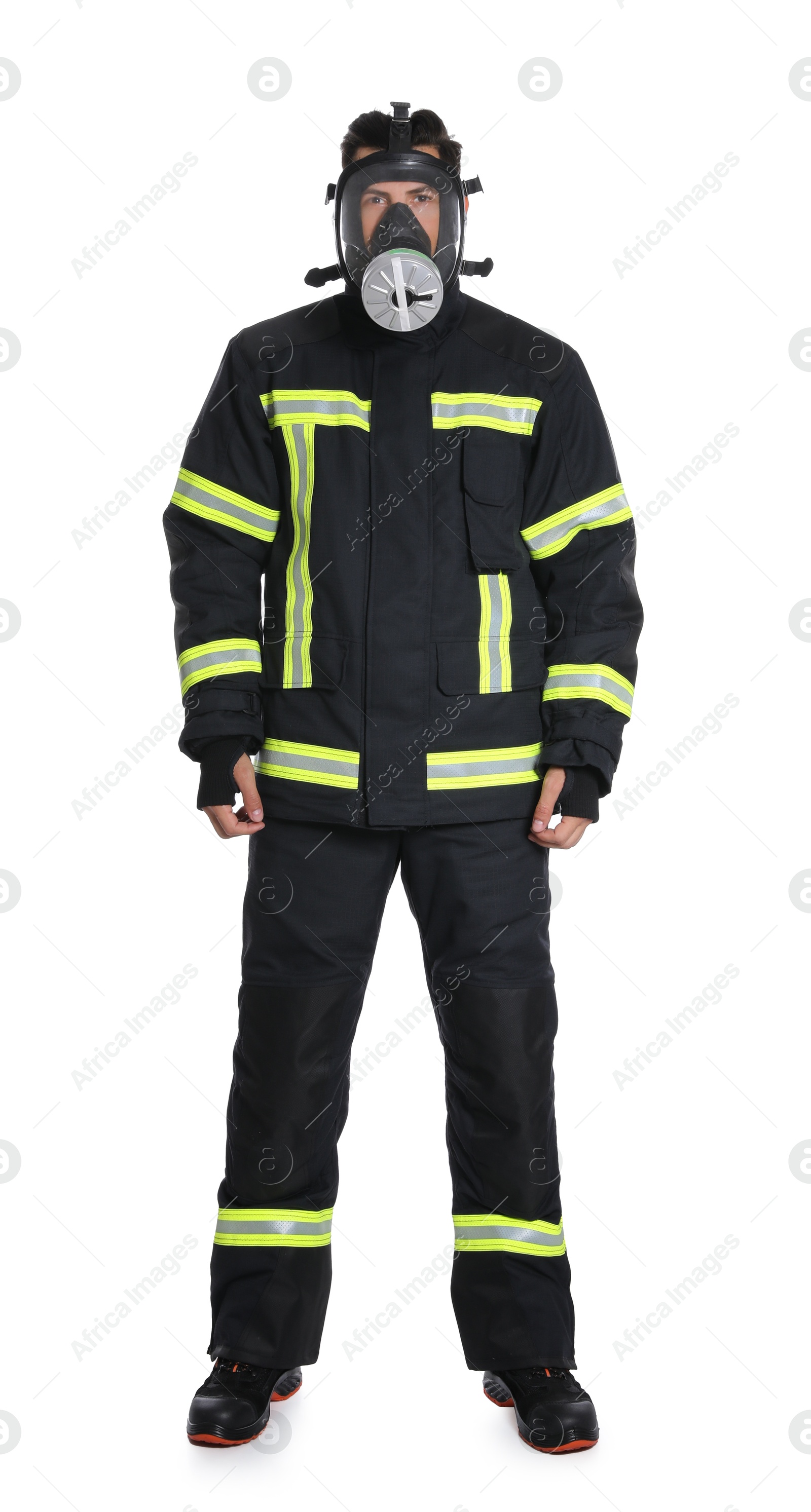 Photo of Full length portrait of firefighter in uniform and gas mask on white background