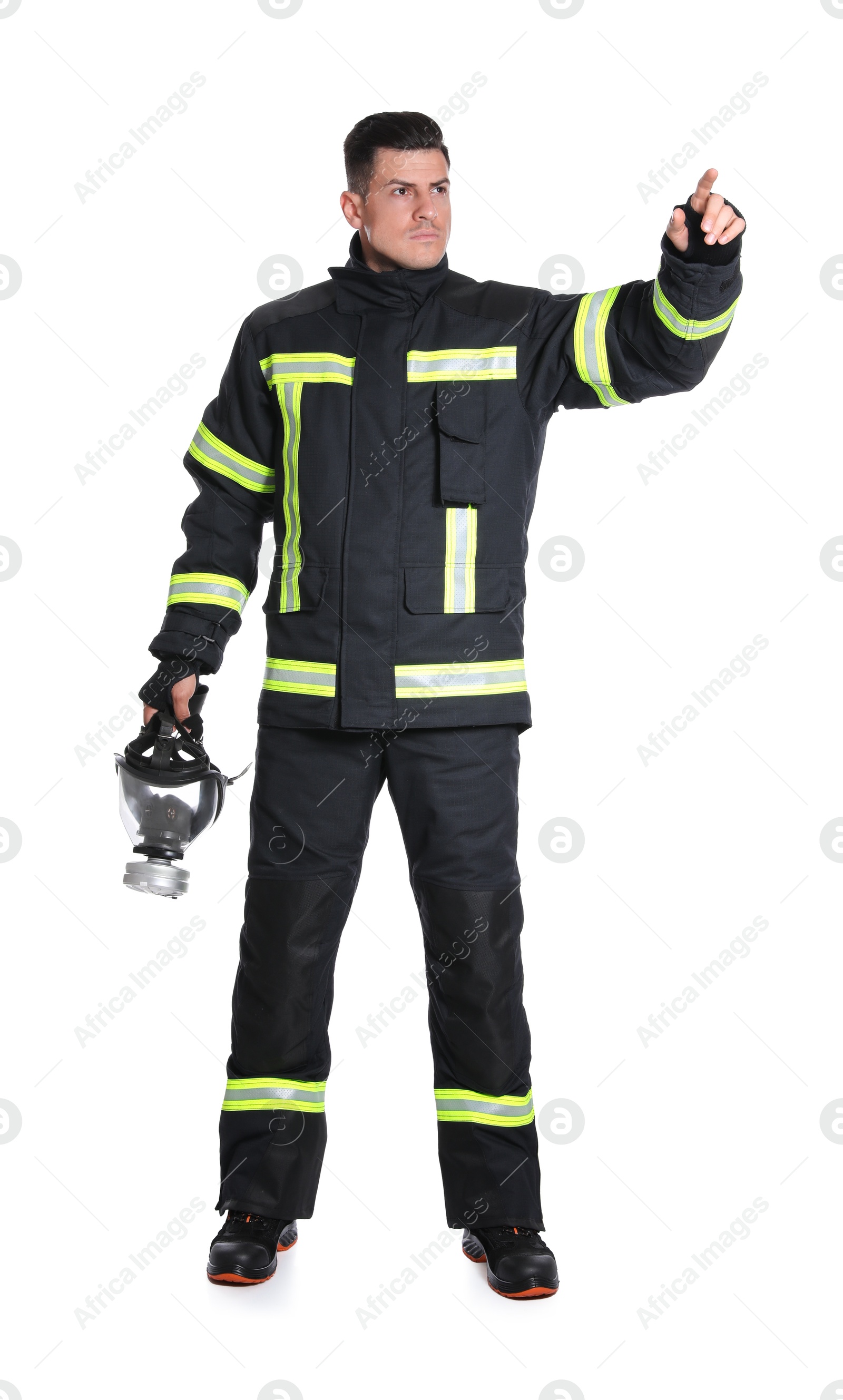 Photo of Full length portrait of firefighter in uniform with gas mask on white background