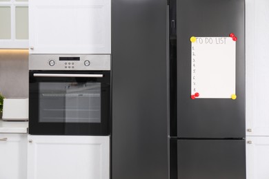 Photo of Magnetic board with to do list on refrigerator in kitchen