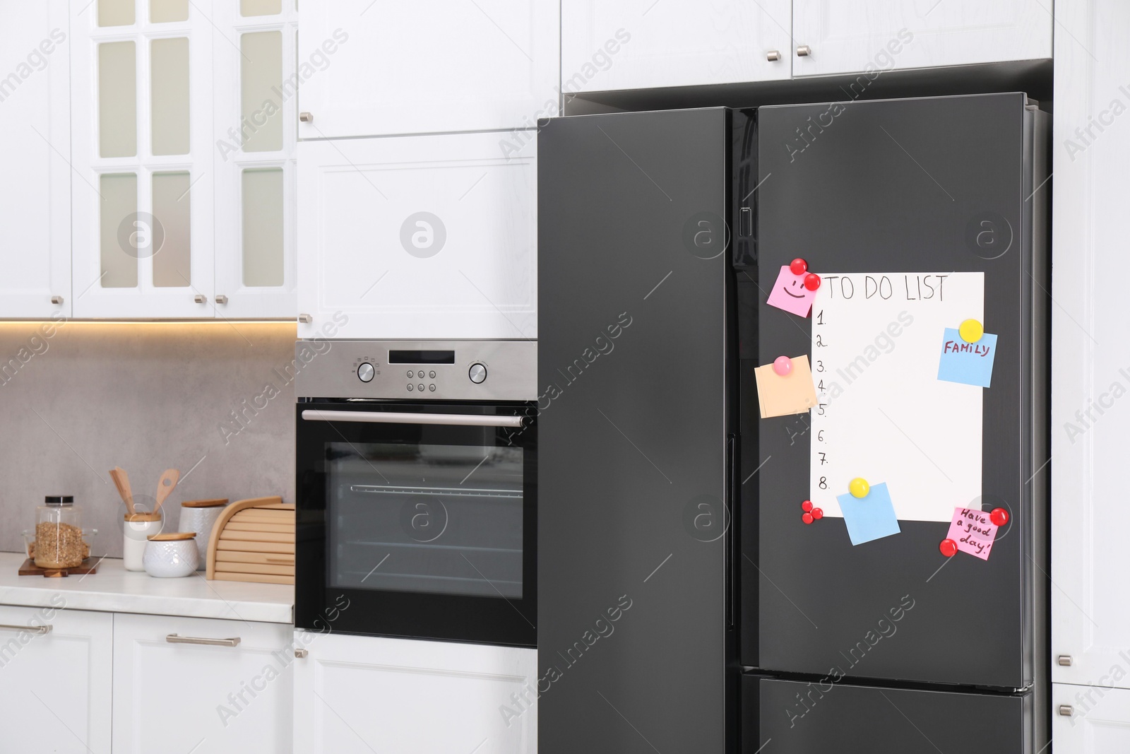 Photo of Magnetic board with to do list and notes on refrigerator in kitchen