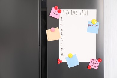 Photo of Magnetic board with to do list and notes on refrigerator in kitchen