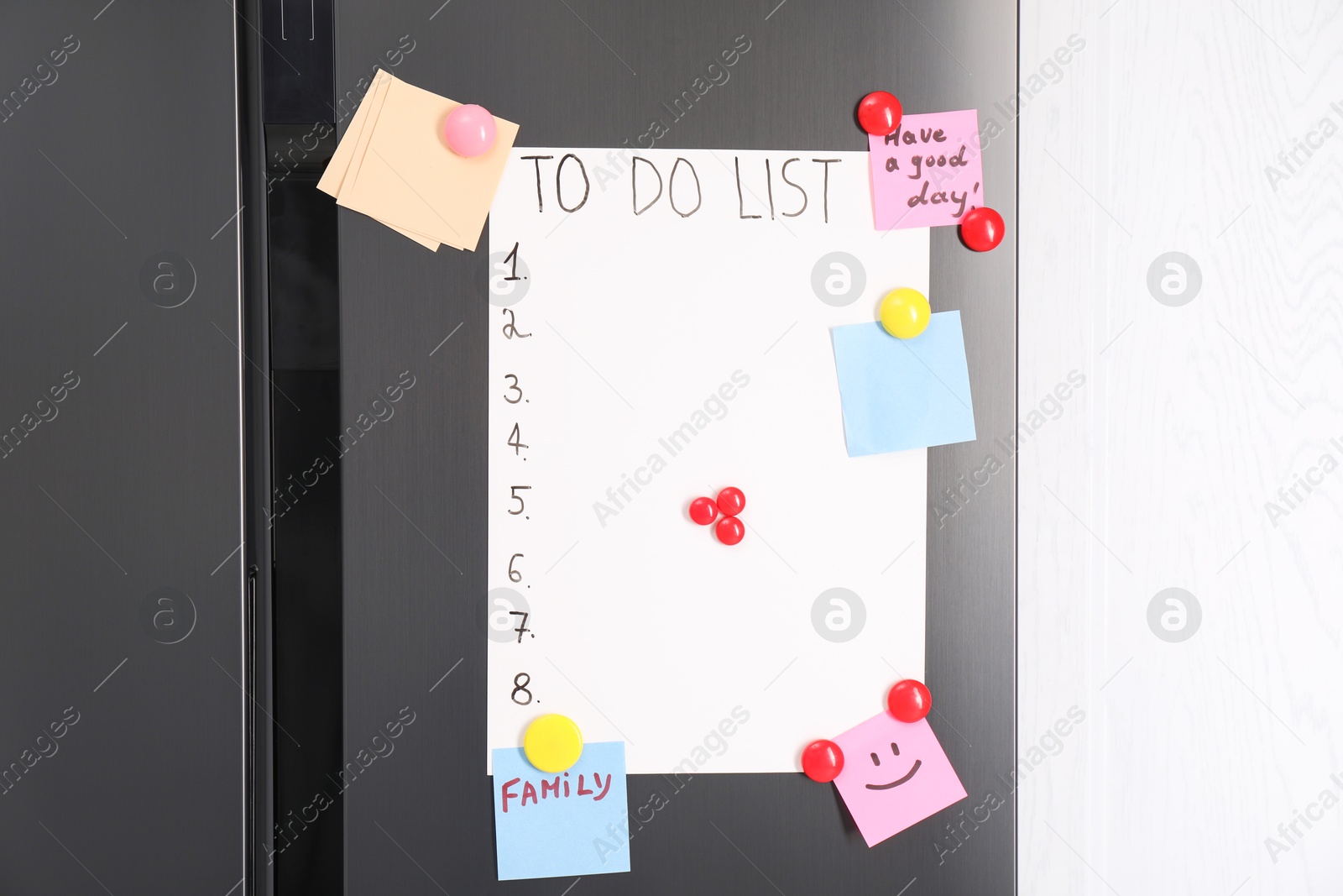 Photo of Magnetic board with to do list and notes on refrigerator in kitchen