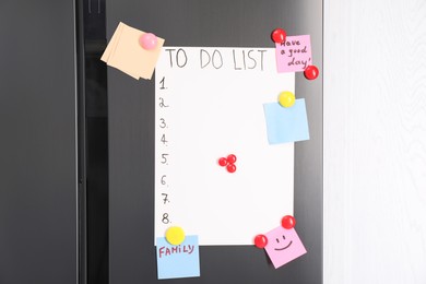 Magnetic board with to do list and notes on refrigerator in kitchen