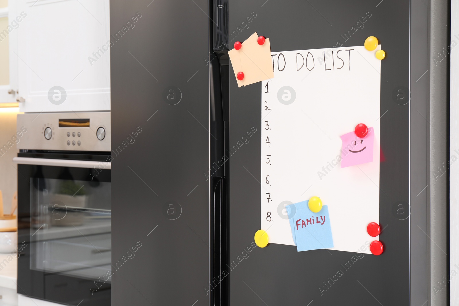 Photo of Magnetic board with to do list and notes on refrigerator in kitchen