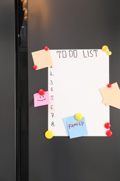 Photo of Magnetic board with to do list and notes on refrigerator