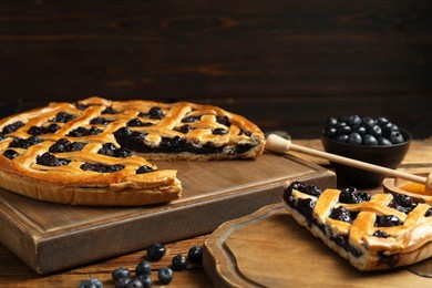 Tasty homemade pie with blueberries served on wooden table