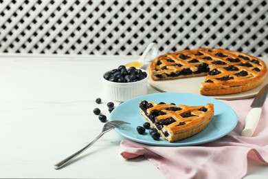 Photo of Tasty homemade pie with blueberries served on white marble table