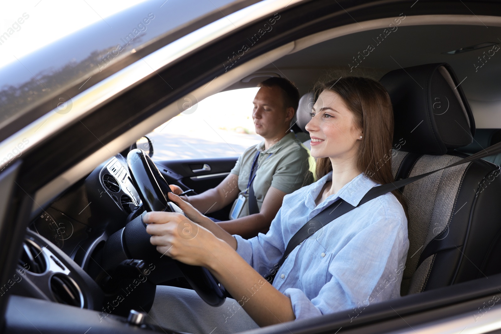 Photo of Driving school. Student passing driving test with examiner in car