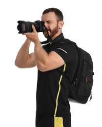 Photographer with backpack and camera taking picture on white background