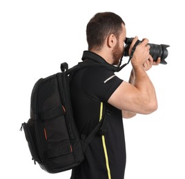 Photographer with backpack and camera taking picture on white background