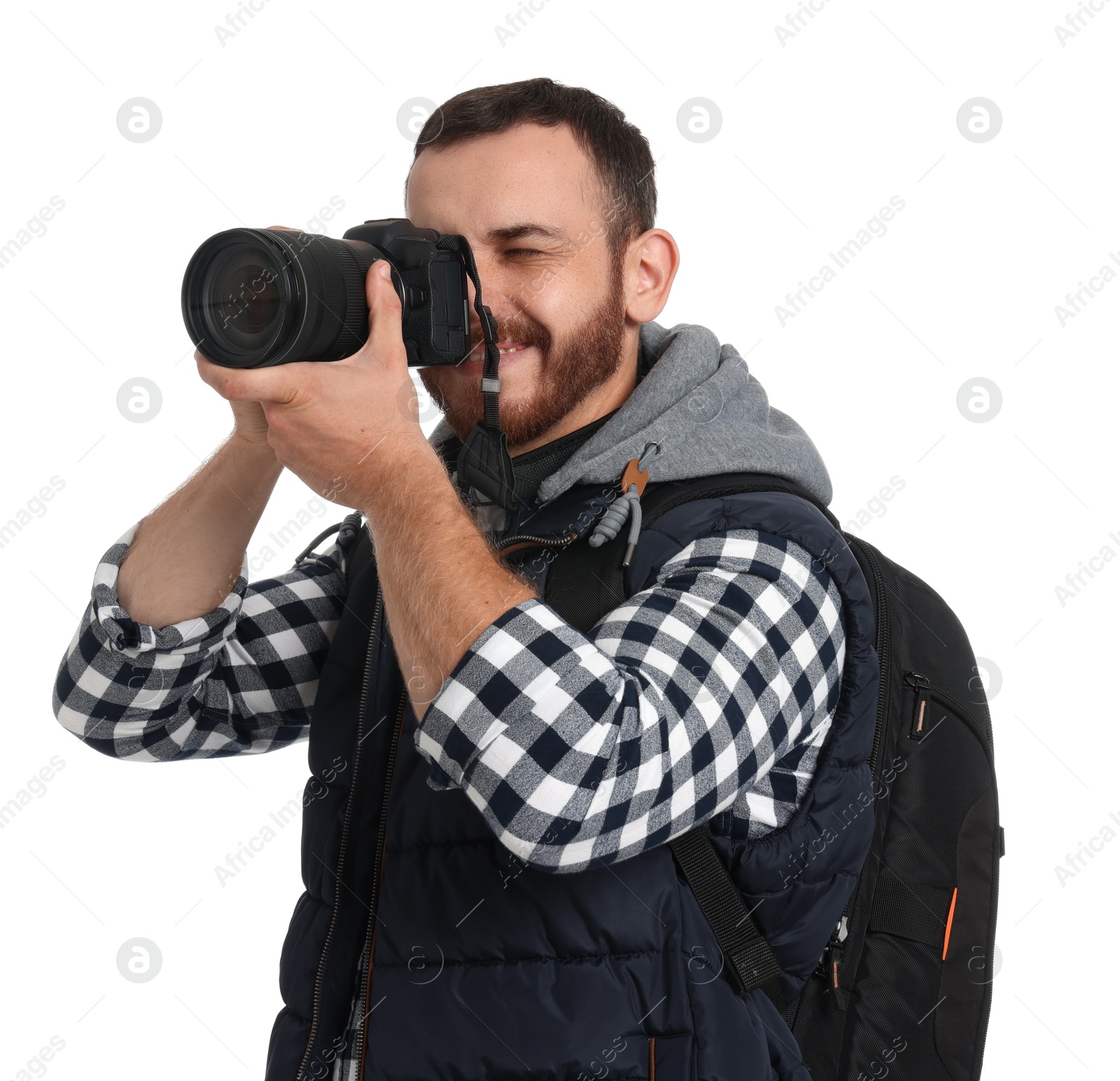 Photo of Photographer with backpack and camera taking picture on white background