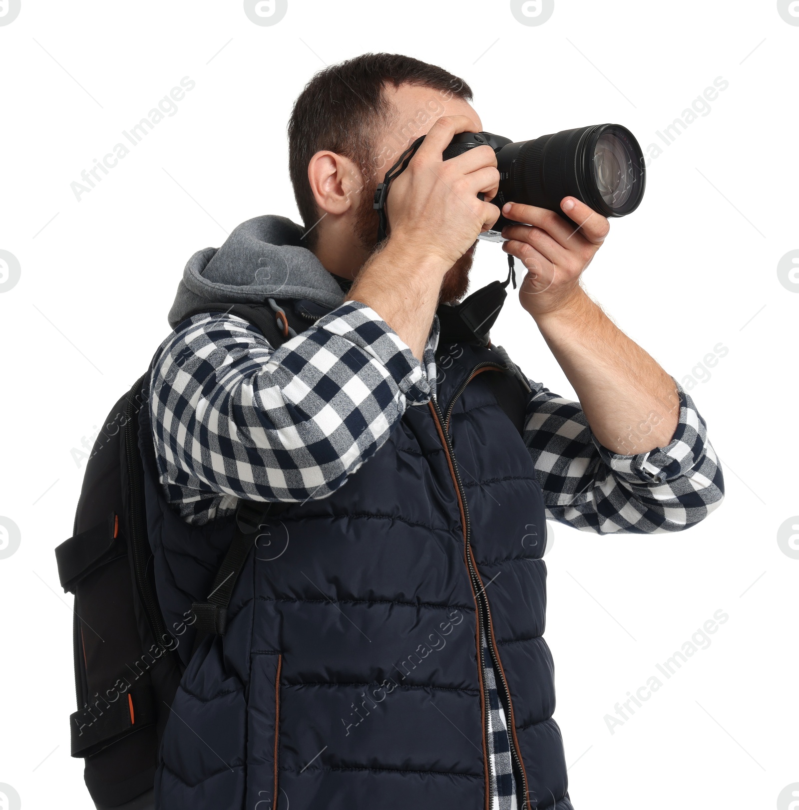 Photo of Photographer with backpack and camera taking picture on white background