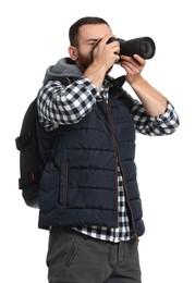 Photographer with backpack and camera taking picture on white background