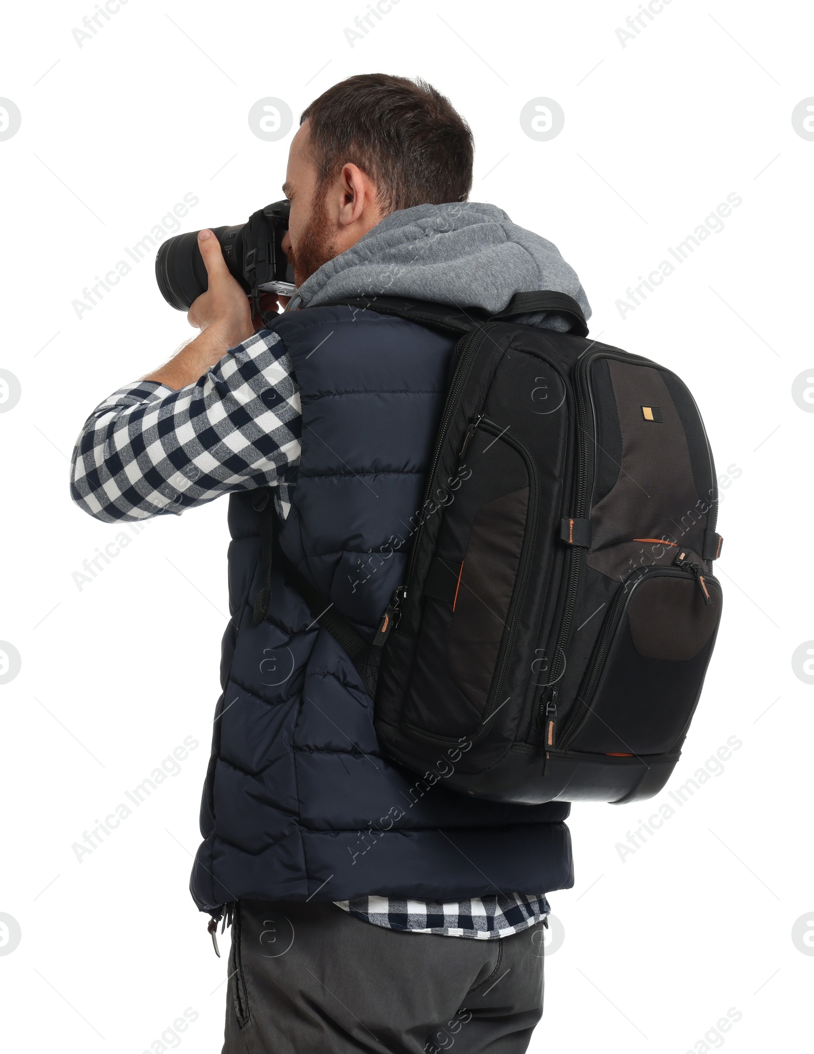 Photo of Photographer with backpack and camera taking picture on white background, back view