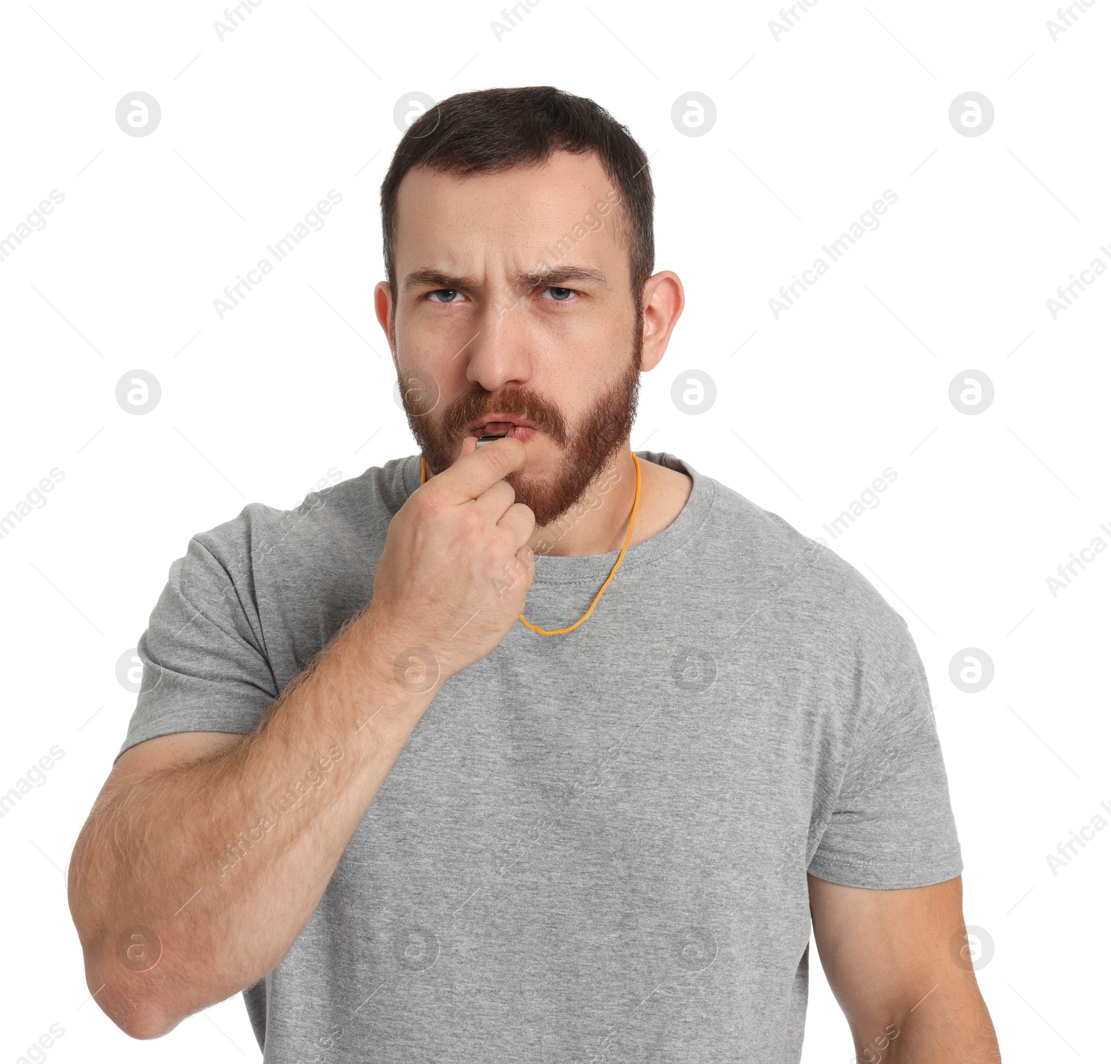 Photo of Young man blowing whistle on white background