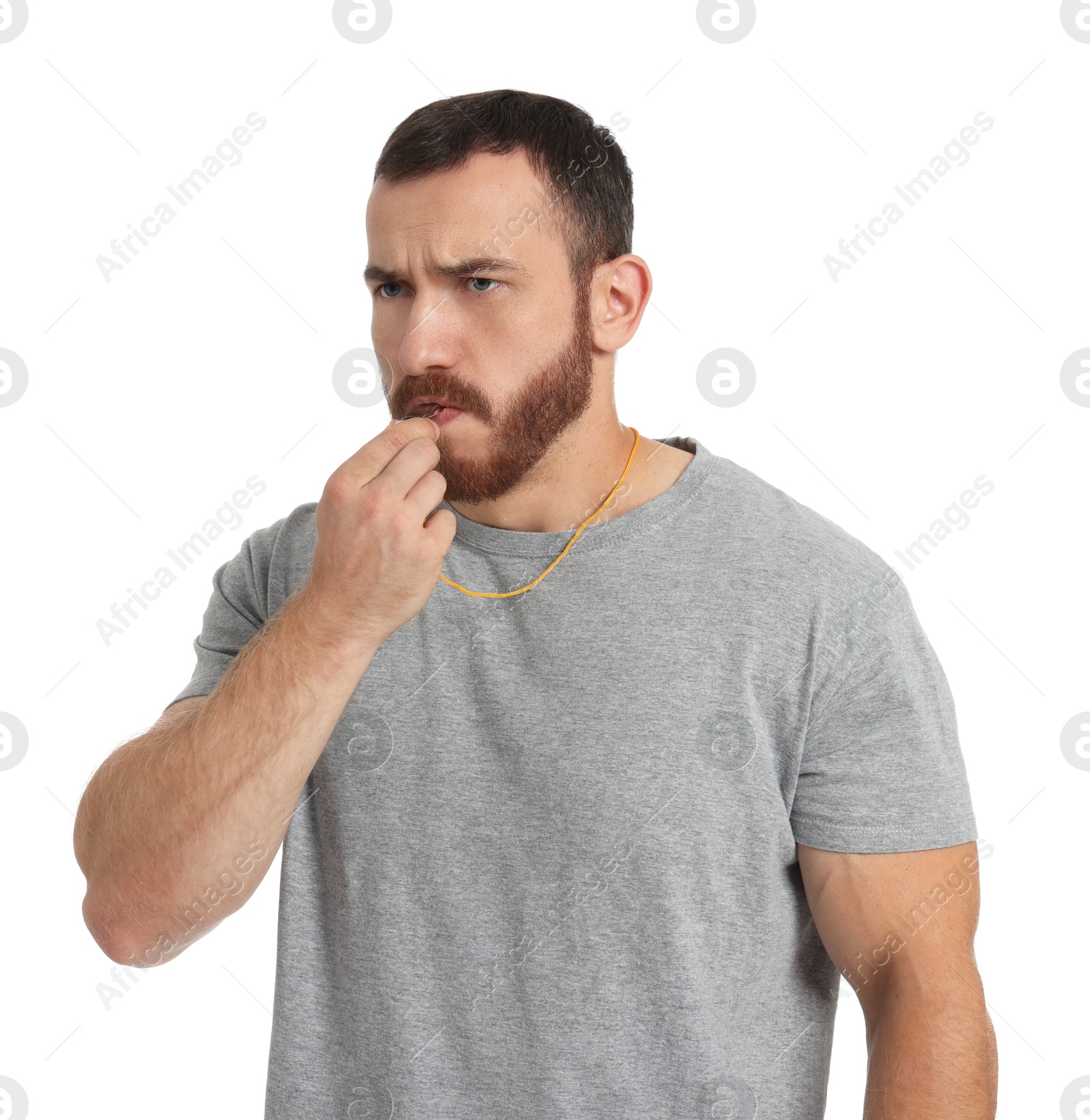 Photo of Young man blowing whistle on white background