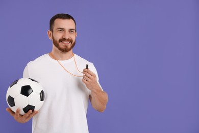 Happy young man with whistle on purple background, space for text