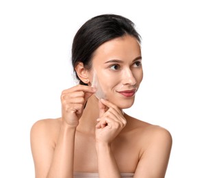 Photo of Beautiful woman peeling off face mask on white background