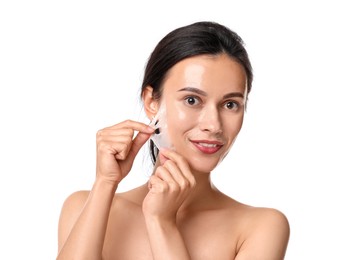 Photo of Beautiful woman peeling off face mask on white background