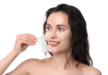 Photo of Smiling woman peeling off face mask on white background