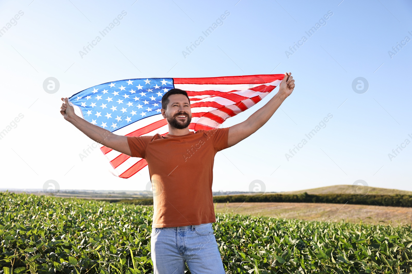 Photo of Happy man with flag of USA outdoors