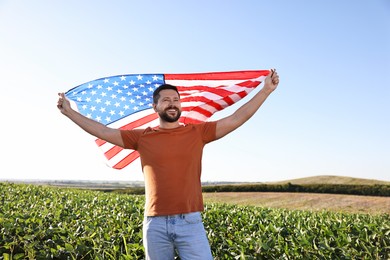 Happy man with flag of USA outdoors